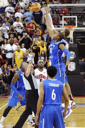 In this photo provided by the Las Vegas News Bureau, United States Olympic men's basketball team member Tyson Chandler, rear, tips off against Dominican Republic's Al Horford during an exhibition game, Thursday, July 12, 2012, in Las Vegas. The U.S. won 113-59. (AP Photo/Las Vegas News Bureau, Brian Jones)