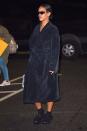 <p>Going casual in a navy robe, slippers, socks and her Dior collaboration sunglasses </p>