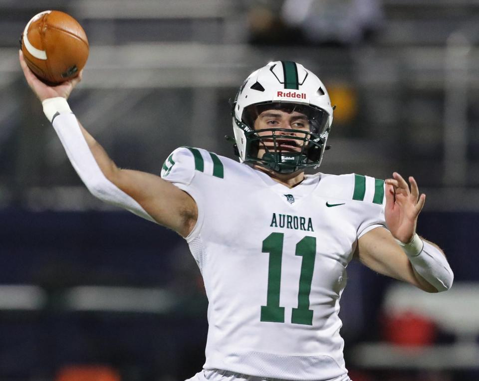 Aurora quarterback Brandon Liepins throws a pass against Barberton, Oct. 13, 2023.