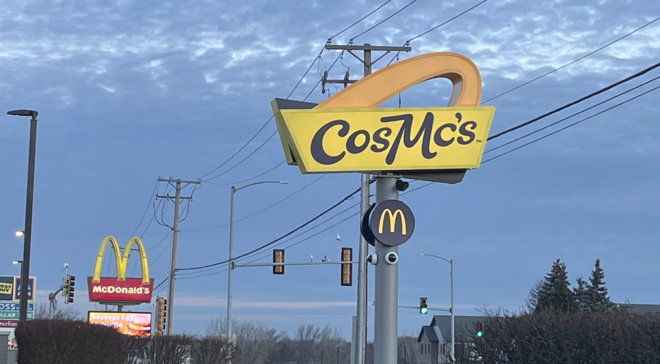 The CosMc's sign in front of the sunrise. Slightly behind it is a McDonald's sign.