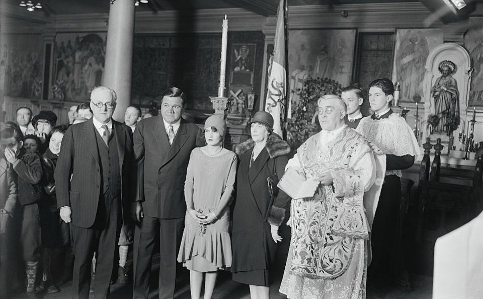 Babe Ruth and his second wife, Claire Hodgson, pose with the priest who performed their marriage ceremony in New York. <a href="https://www.gettyimages.com/detail/news-photo/ruth-and-bride-babe-ruth-wedding-at-st-gregorys-l-to-r-news-photo/515170948?adppopup=true" rel="nofollow noopener" target="_blank" data-ylk="slk:Bettmann via Getty Images;elm:context_link;itc:0;sec:content-canvas" class="link ">Bettmann via Getty Images</a>