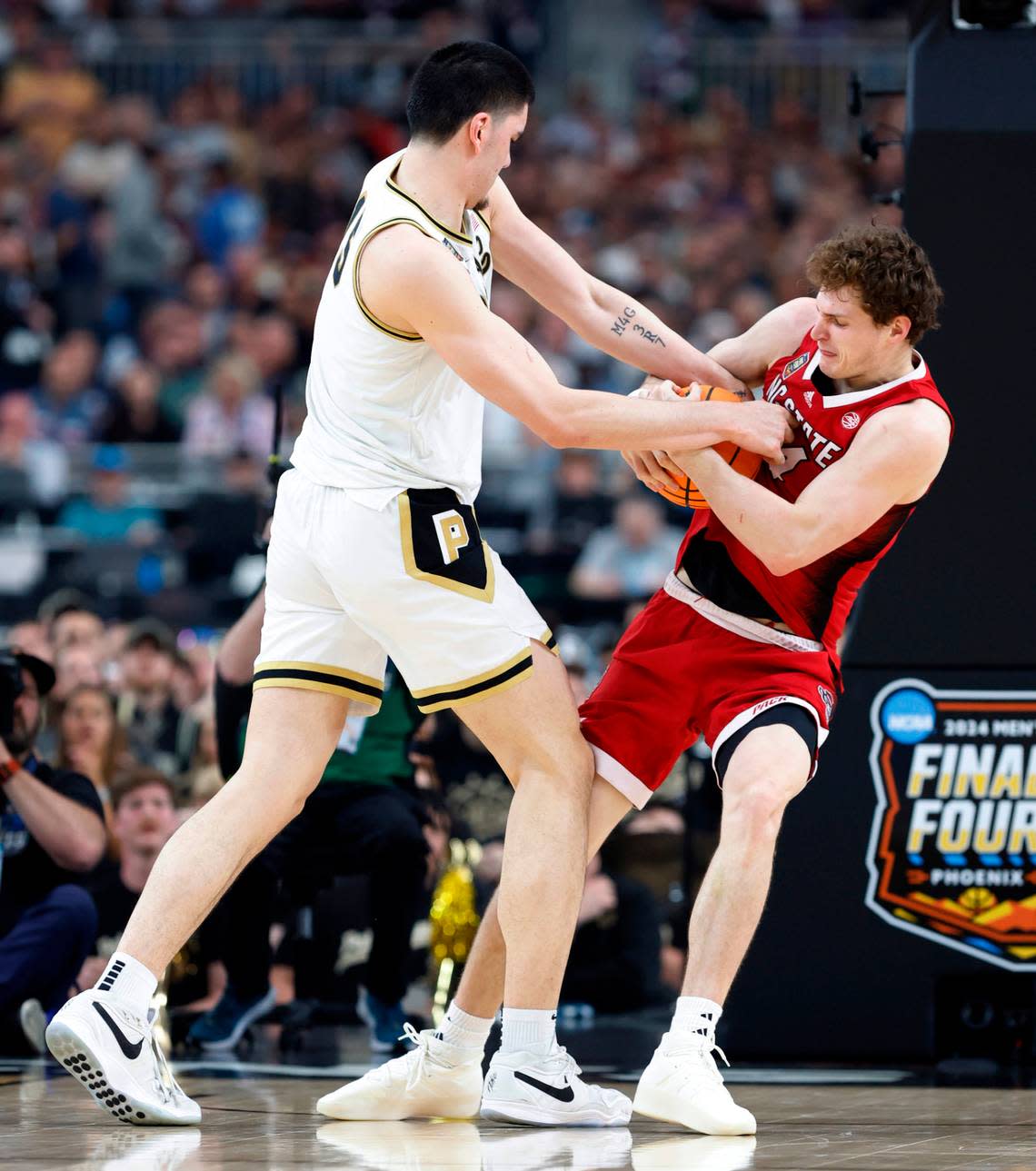 NC State’s Ben Middlebrooks ties up the ball against Purdue’s Zach Edey in second half action of their Final Four game, Saturday, April 6, 2024. Ethan Hynan/ehyman@newsobserver.com