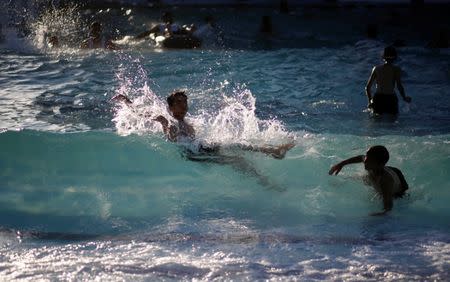 Palestinian boys swim at Sharm Park Water City, in Gaza July 9, 2018. Picture taken July 9, 2018. REUTERS/Mohammed Salem