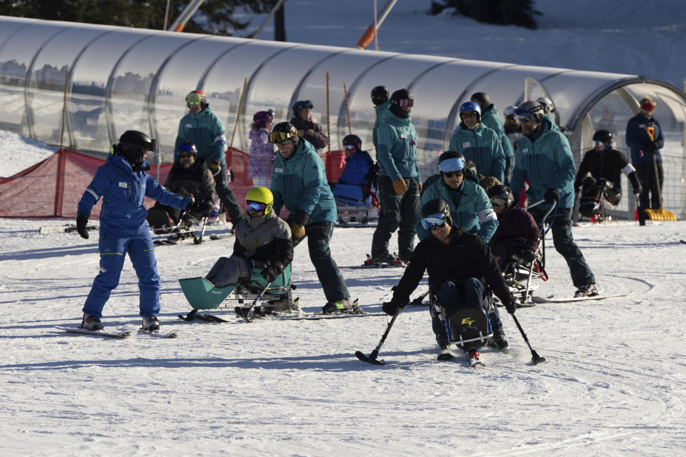 Britain's Prince Harry, right front, skis with athletes during the Invictus Games training camp in Whistler, Canada, on Wednesday, Feb. 14, 2024. (Ethan Cairns/The Canadian Press via AP)