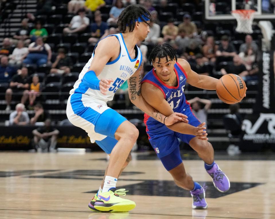 76ers guard Jaden Springer (11) drives as Thunder guard Caleb McConnell (55) defends during the first half Thursday in Salt Lake City.