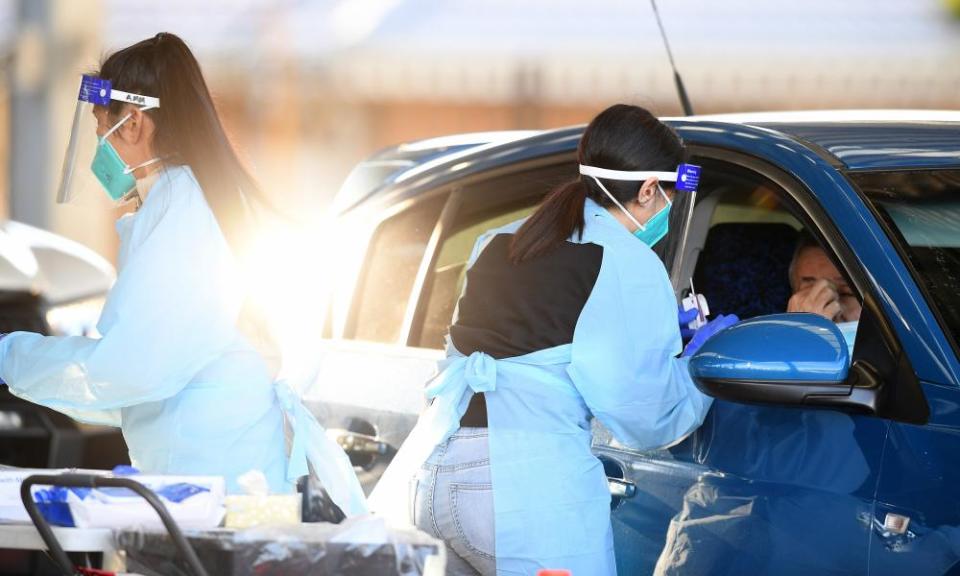 Health workers administer Covid tests at a drive-through testing clinic at Fairfield in Sydney.