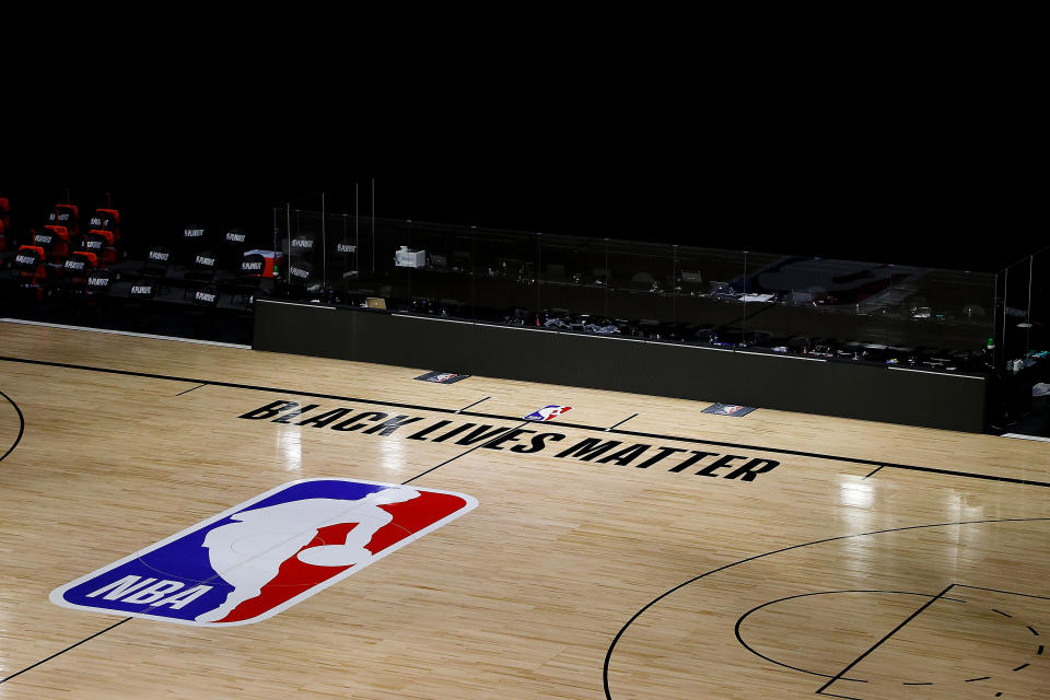 An empty NBA court with Black Lives Matter painted on the floor.