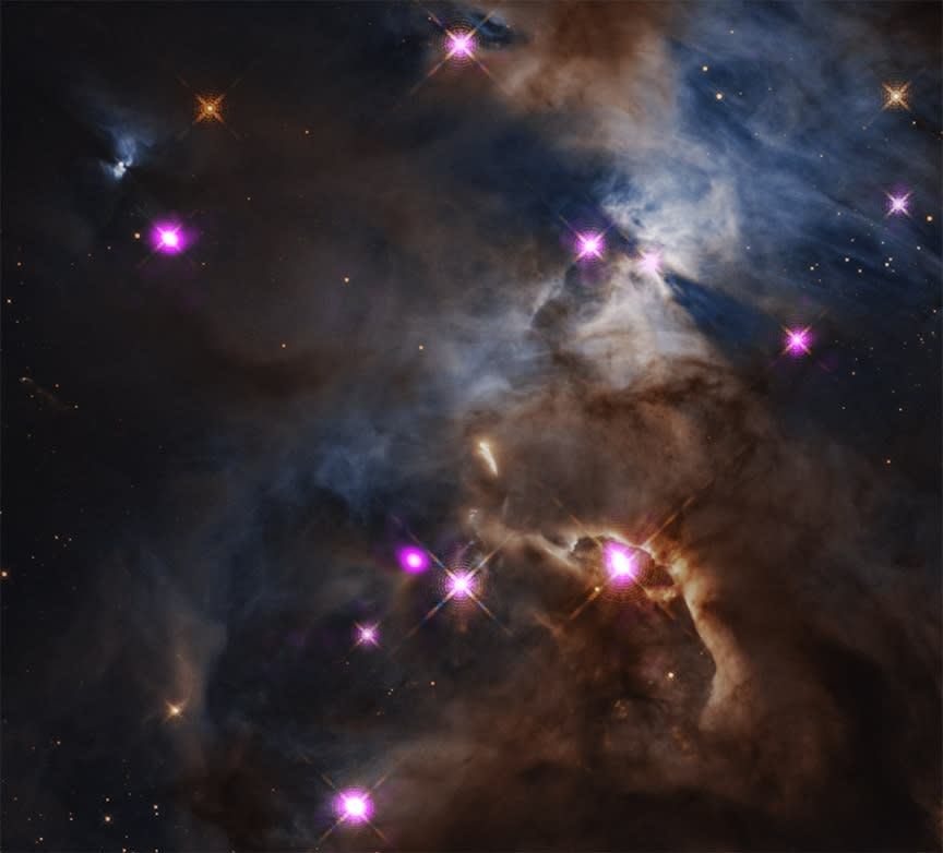 A cloudy area of space with a few glowing pink dots throughout.