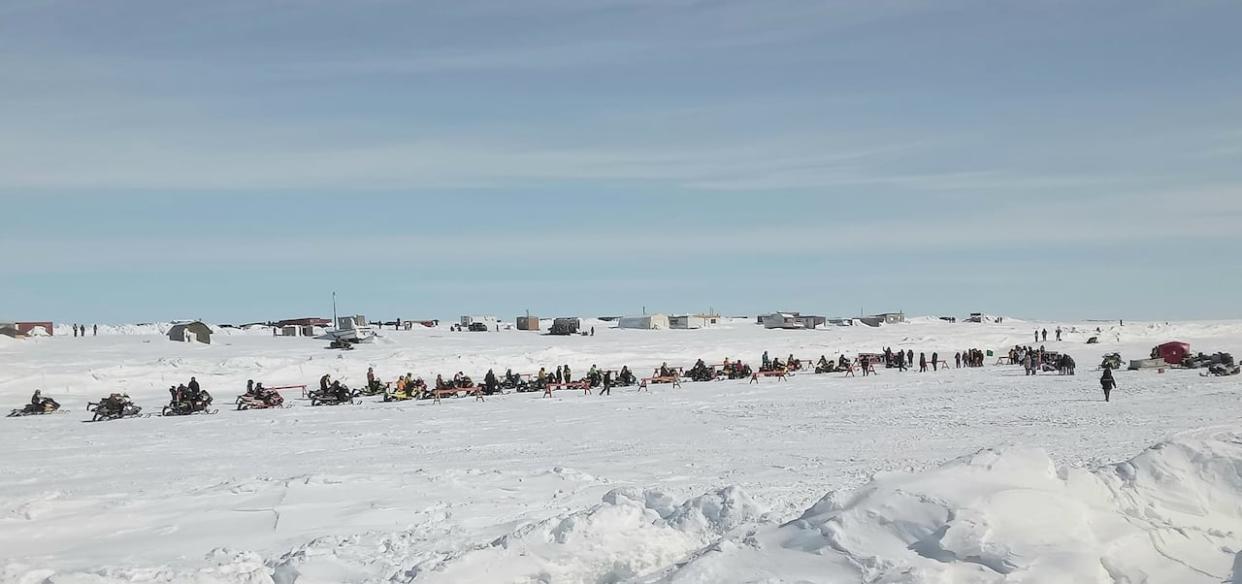 Racers line up for the start of the Rankin Inlet to Whale Cove, Nunavut snowmobile race on Sunday, April 7, 2024.  (Submitted by Abby Naukatsik  - image credit)