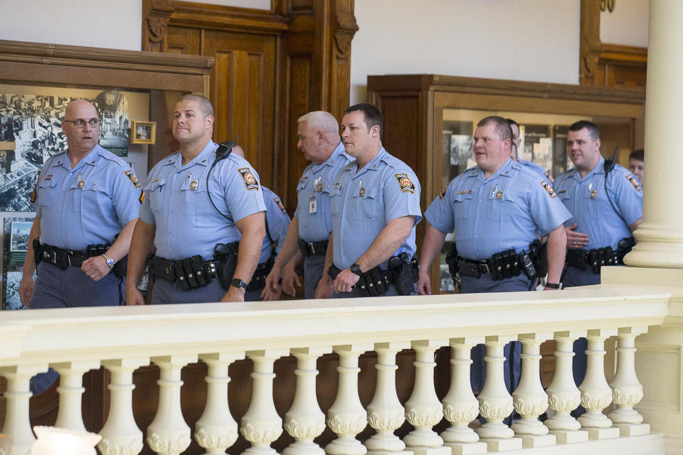 Georgia State Troopers walk toward the Senate chambers gallery during the 35th legislative day at the Georgia State Capitol building in downtown Atlanta, Friday, March 22, 2019. The Georgia Senate is set for a lengthy debate on the anti-abortion "heartbeat bill" Friday. Sen. Renee Unterman is carrying the bill for Rep. Ed Setzler. (Alyssa Pointer/Atlanta Journal-Constitution via AP)