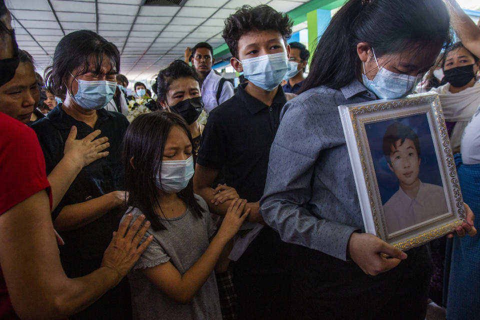 Family members of Khant Ngar Hein grieve during his funeral in Yangon, Myanmar Tuesday, March 16, 2021. Khant Ngar Hein, a 18-year old student of medicine was shot on his chest on Sunday, March 14, in Tamwe, Yangon by security forces during an anti-crop protest. Demonstrators in several areas of Myanmar protesting last month’s seizure of power by the military held small, peaceful marches before dawn Tuesday, avoiding confrontations with security forces who have shot dead scores of their countrymen in the past few days. (AP Photo)