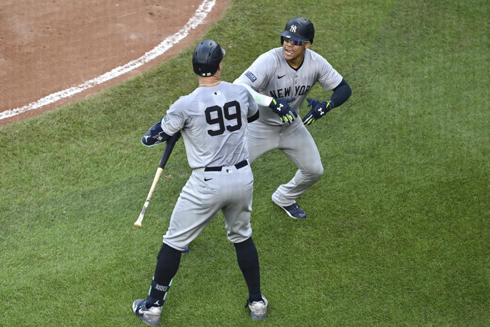 New York Yankees outfielder Juan Soto, right, celebrates after his solo home run with Aaron Judge (99) hit off Baltimore Orioles pitcher Grayson Rodriguez during the fifth inning of a baseball game, Saturday, July 13, 2024, in Baltimore. (AP Photo/Terrance Williams)