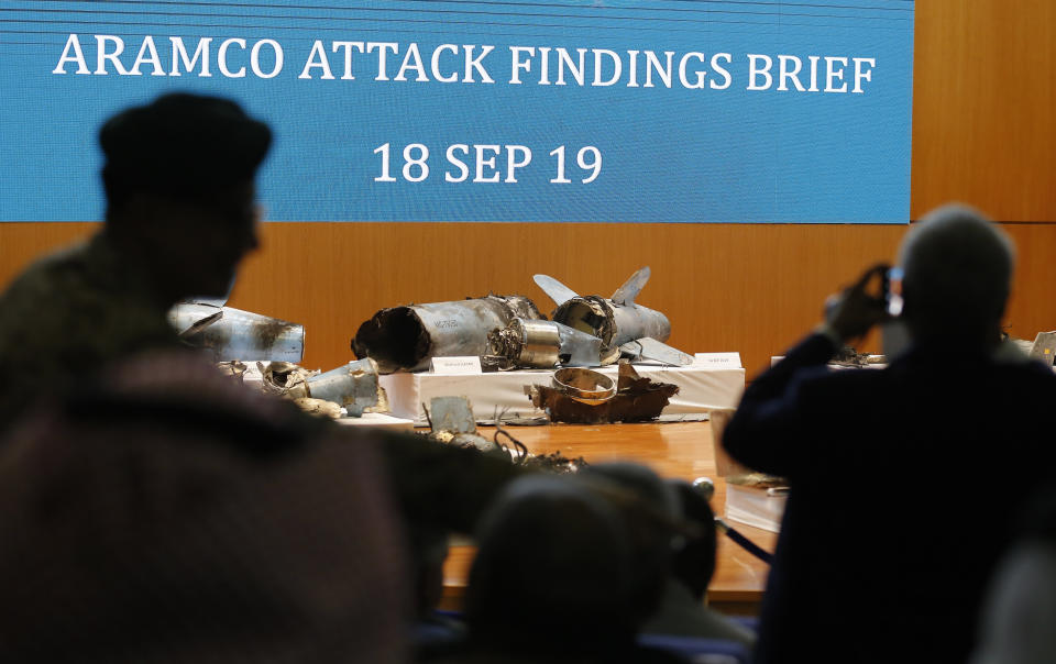 Journalists film what Saudi military spokesman Col. Turki al-Malki said was evidence of Iranian weaponry used in the attack targeted Saudi Aramco's facilities in Abqaiq and Khurais, during a press conference in Riyadh, Saudi Arabia, Wednesday, Sept. 18, 2019. (AP Photo/Amr Nabil)