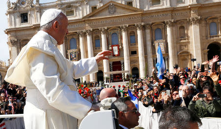 Pope Francis waves from his Papamobile after the Palm Sunday Mass in Saint Peter's Square at the Vatican, March 25, 2018 REUTERS/Stefano Rellandini