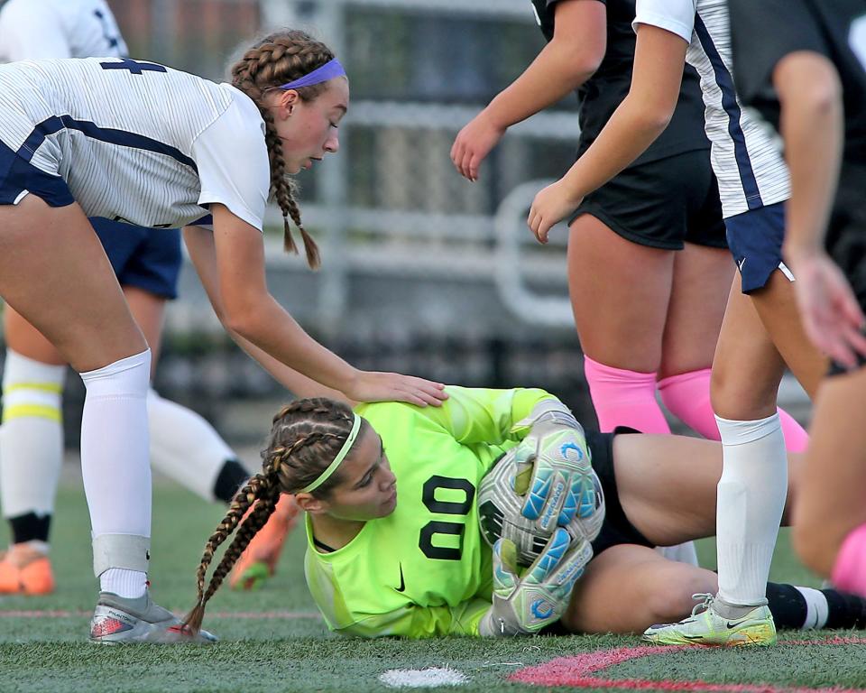 Plymouth North's Elise Majka gives props to Plymouth North goalie Amelia Finley after she made a save to snuff out a Marshfield scoring opportunity during first half action of their game at Marshfield High School on Tuesday, Oct. 24, 2023. Marshfield would draw Plymouth North 1-1 in Patriot League action.