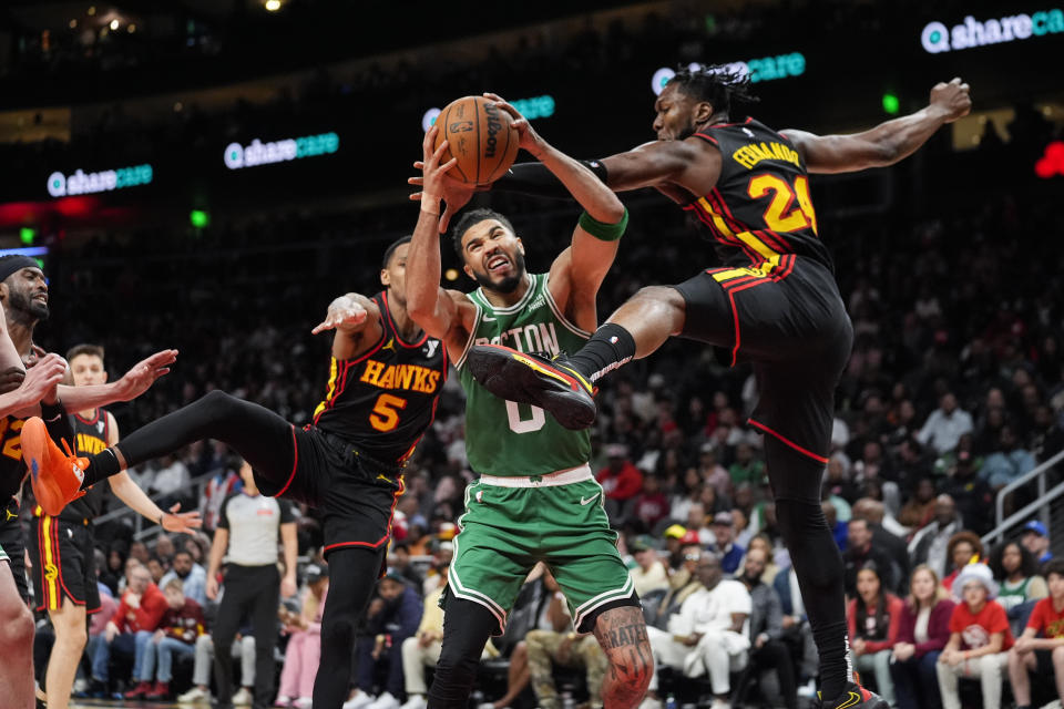 Boston Celtics forward Jayson Tatum (0) is fouled by Atlanta Hawks forward Bruno Fernando (24) during the second half of an NBA basketball game Thursday, March 28, 2024, in Atlanta. (AP Photo/John Bazemore)