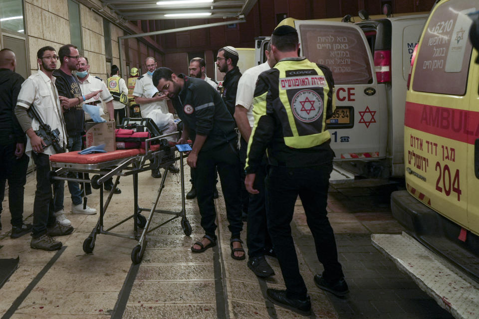 Paramedics gather at a hospital in Jerusalem on Saturday, Oct. 29, 2022, after they evacuated wounded from a shooting attack. A Palestinian militant fired at the entrance to an Israeli settlement in the occupied West Bank Saturday evening, the Israeli military said, wounding several civilians before a security guard shot him dead. (AP Photo/Mahmoud Illean)