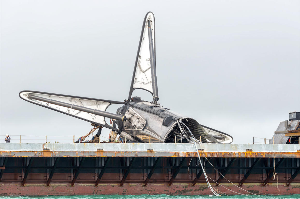  The remains of SpaceX's first Falcon booster to fly astronauts into orbit are seen atop the droneship "Just Read the Instructions" after a mishap following the stage's record 19th launch. 