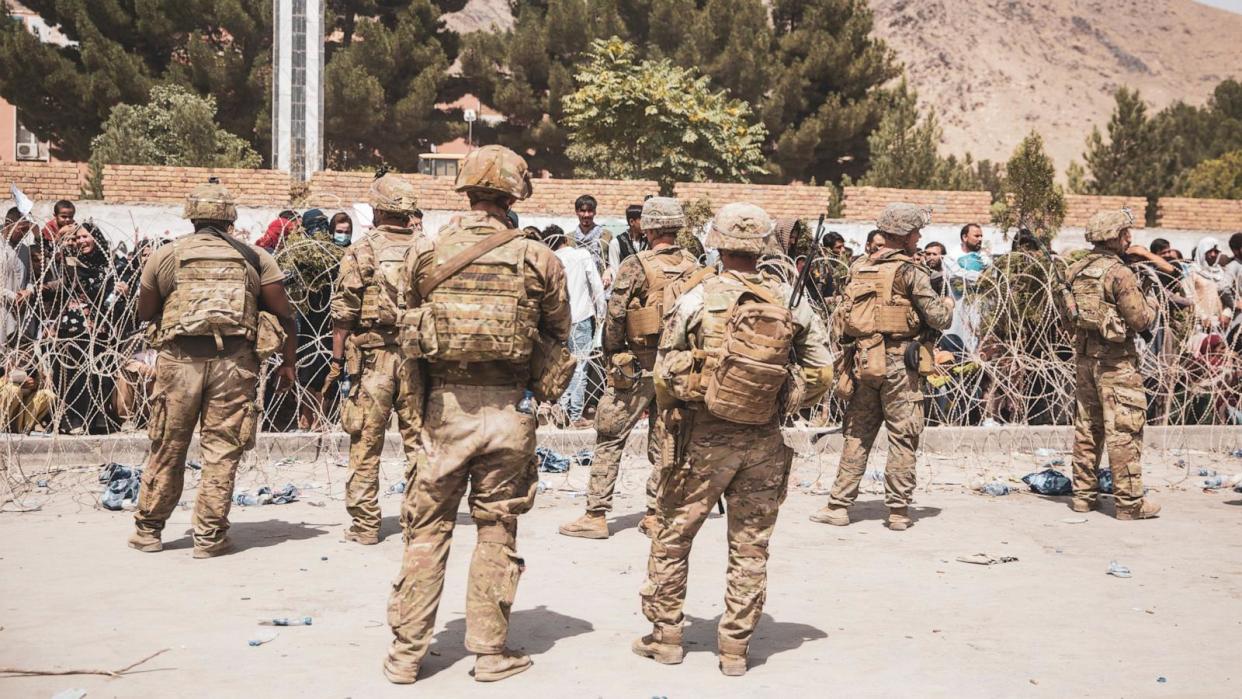 PHOTO: \This handout image shows  U.S. Soldiers and Marines assist with security at an Evacuation Control Checkpoint during an evacuation at Hamid Karzai International Airport in Kabul, Afghanistan, Aug.  19, 2021.  (Staff Sgt. Victor Mancilla / U.S. Marine Corps via Getty Images)