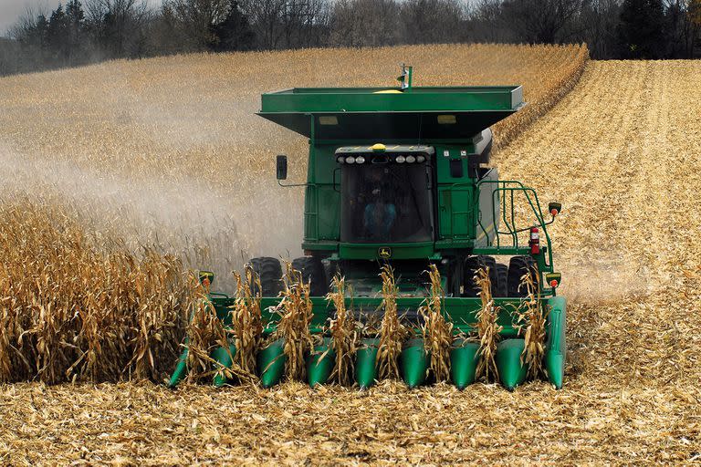 A farmer drives a large John Deere combine to harvest a field of corn in Fairmont Minnesota 10-01-20.