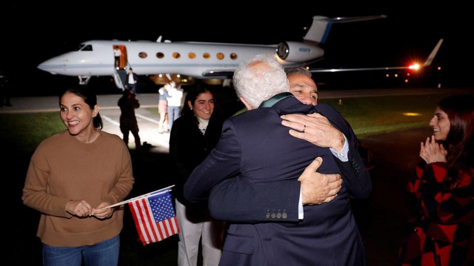 PHOTO: Family members embrace freed Americans Siamak Namazi, Morad Tahbaz and Emad Shargi as well as two returnees whose names have not yet been released by the U.S. government at Fort Belvoir, Va., Sept. 19, 2023. (Jonathan Ernst/Reuters)