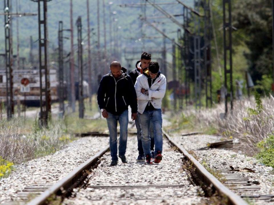 Migrants from Syria cross the railways at the border post of Idomeni at the Greece-Macedonia border on April 21 (AFP/Getty Images)