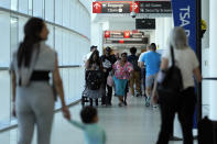 Travelers walk through the Philadelphia International Airport, Wednesday, July 3, 2024, in Philadelphia. (AP Photo/Matt Slocum)