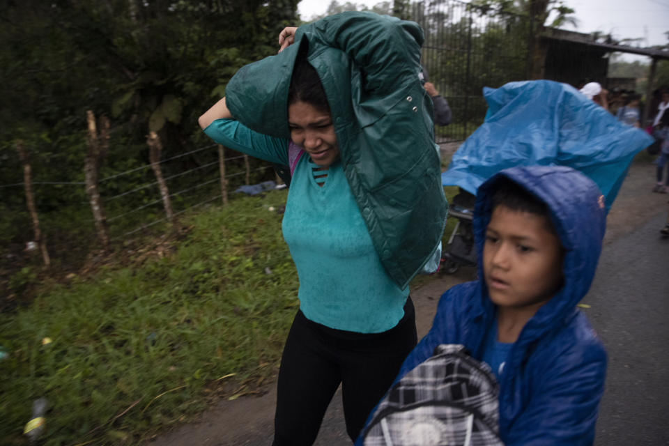 Honduran migrants cover themselves from the rain during their journey toward the distant United States, in Entre Rios, Guatemala, Thursday, Jan. 16, 2020. Less-organized migrants, tighter immigration control by Guatemalan authorities and the presence of U.S. advisers have reduced the likelihood that the hundreds of migrants who departed Honduras will form anything like the cohesive procession the term “caravan” now conjures. (AP Photo/Moises Castillo)