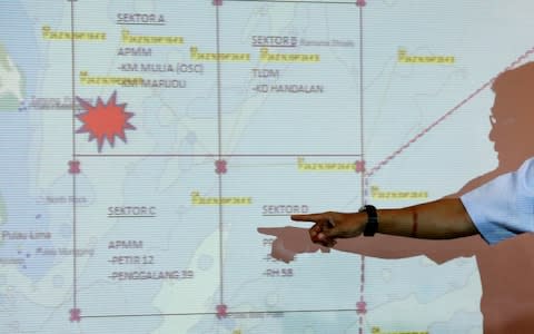 A Malaysia Maritime Enforcement Agency (MMEA) officer shows to the media the area of the search and rescue operations for missing personnel of USS John S. McCain in Putrajaya, Malaysia - Credit: Reuters