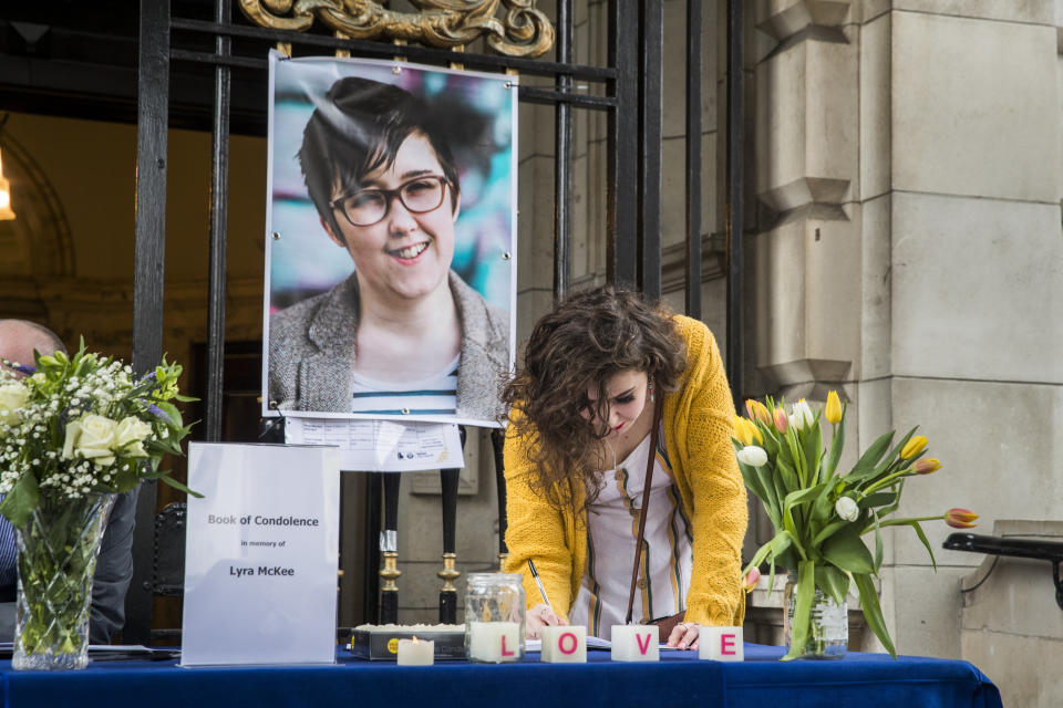 People signing a book of condolence after a vigil at Belfast City Hall in memory of murdered journalist Lyra McKee (Picture: PA)