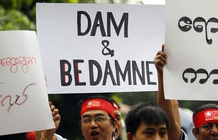 FILE PHOTO - Myanmareses living in Malaysia display placards in protest against the Myitsone dam project, outside Myanmar's embassy in Kuala Lumpur September 22, 2011. REUTERS/Bazuki Muhammad