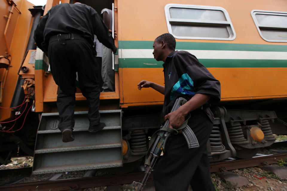 In this Photo taken, Friday, March . 8, 2013, Nigeria policeman board an Ooni of Ife train to provide security for passengers traveling to Kano, in Lagos, Nigeria. Nigeria reopened its train line to the north Dec. 21, marking the end of a $166 million project to rebuild portions of the abandoned line washed out years earlier. The state-owned China Civil Engineering Construction Corp. rebuilt the southern portion of the line, while a Nigerian company handled the rest. ( AP Photo/Sunday Alamba)