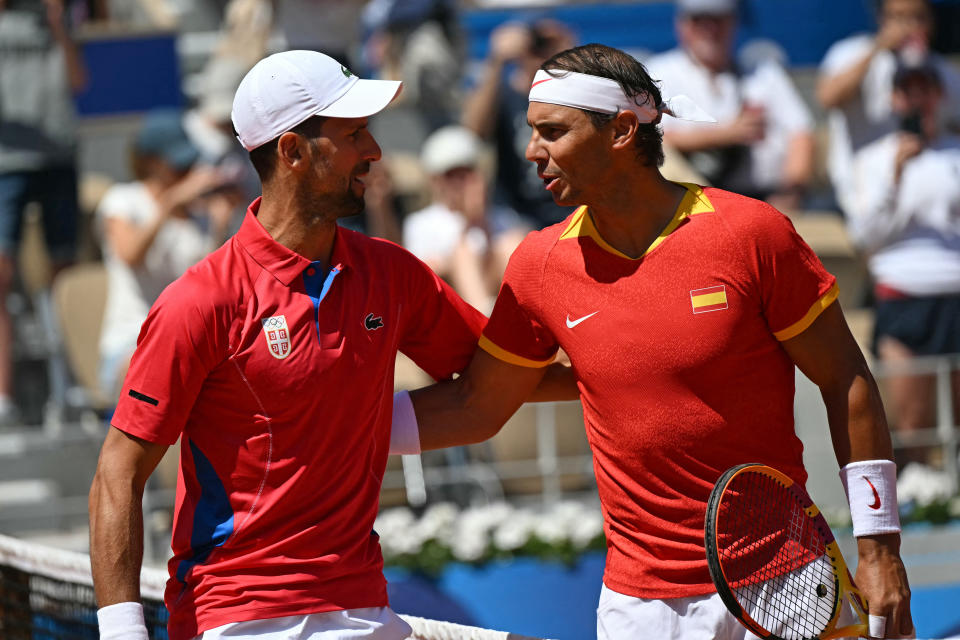 Serbia's Novak Djokovic (L) and Spain's Rafael Nadal (R) speak ahead of their men's singles second round tennis match on Court Philippe-Chatrier at the Roland-Garros Stadium at the Paris 2024 Olympic Games, in Paris on July 29, 2024. (Photo by MARTIN BERNETTI / AFP) (Photo by MARTIN BERNETTI/AFP via Getty Images)