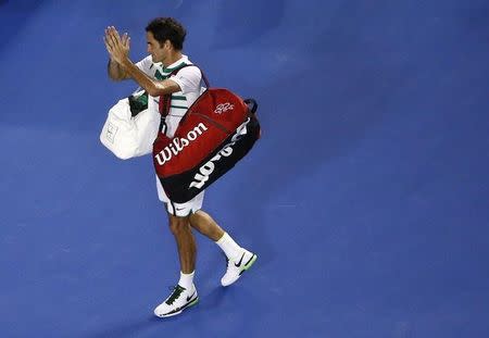 Switzerland's Roger Federer claps as he leaves after losing his semi-final match against Serbia's Novak Djokovic at the Australian Open tennis tournament at Melbourne Park, Australia, January 28, 2016. REUTERS/Jason Reed