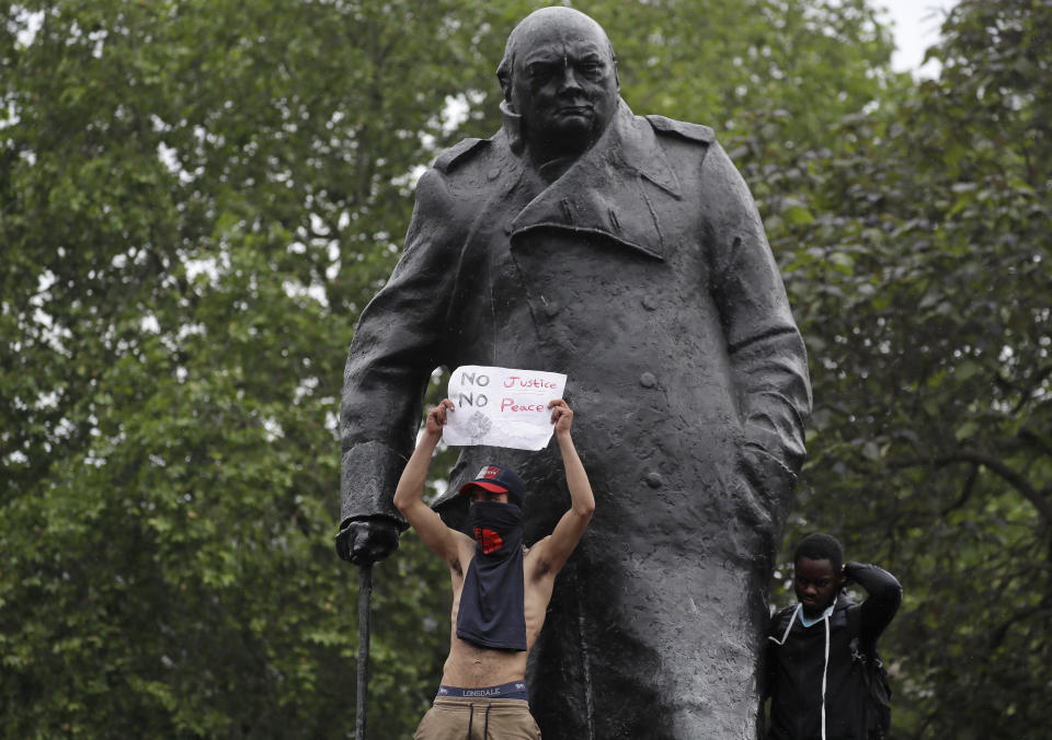 Protesters stand on the statue of former British Prime Minister Winston Churchill during a demonstration in Parliament Square in London on Wednesday, June 3, 2020, over the death of George Floyd, a black man who died after being restrained by Minneapolis police officers on May 25. Protests have taken place across America and internationally, after a white Minneapolis police officer pressed his knee against Floyd's neck while the handcuffed black man called out that he couldn't breathe. The officer, Derek Chauvin, has been fired and charged with murder. (AP Photo/Kirsty Wigglesworth)
