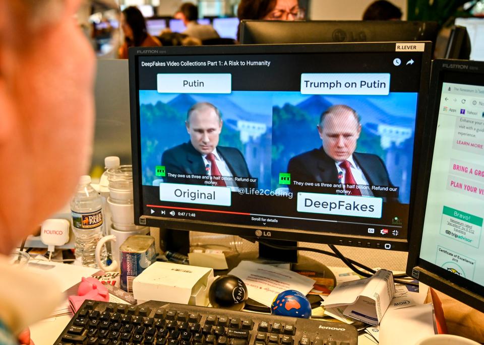 A journalist views video manipulated with artificial intelligence to potentially deceive viewers, or “deepfake” (AFP via Getty Images)