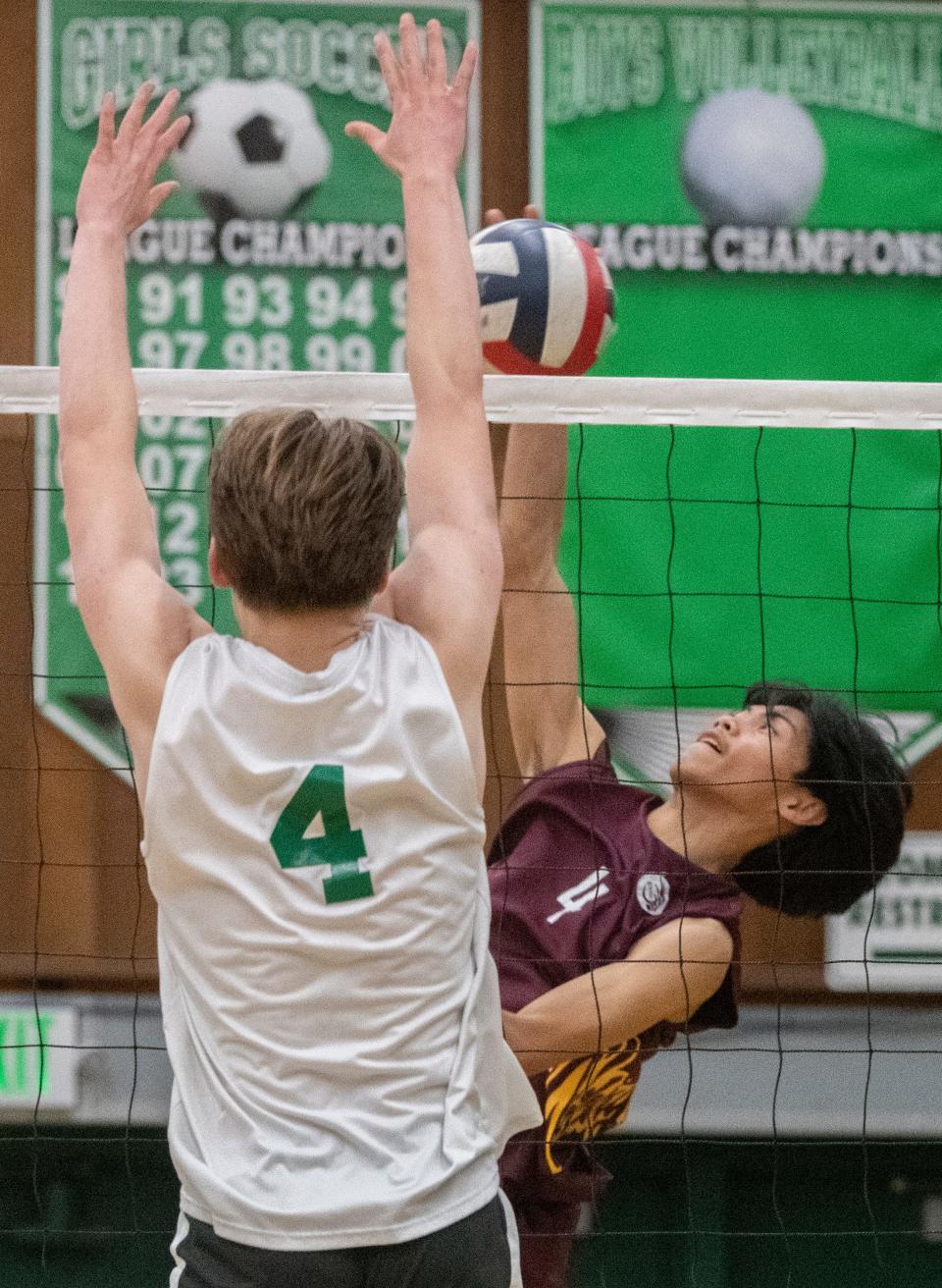 Edison's Vince Tanega, right, spikes the ball on St. Mary's John Ragpala during a Sac-Joaquin Section boys volleyball playoff match at St. Mary's in Stockton on May. 2, 2024. St. Mary's won 3-1.