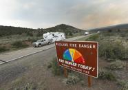 <p>People remove travel trailers down highway 143 from their homes that have been evacuated due to a wildfire on June 25, 2017 outside Panguitch, Utah. (George Frey/Getty Images) </p>