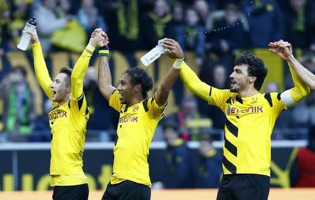 Borussia Dortmund's Marco Reus, Pierre-Emerick Aubameyang and Mats Hummels (L-R) celebarate after defeating Schalke 04 in their German first division, Bundesliga soccer match in Dortmund February 28, 2015. REUTERS/Ralph Orlowski