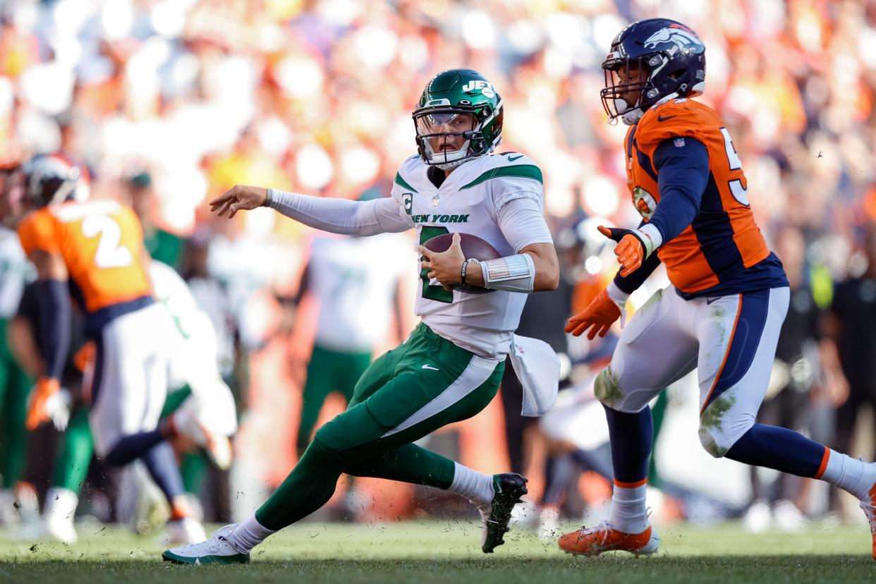 Sep 26, 2021; Denver, Colorado, USA; New York Jets quarterback Zach Wilson (2) scrambles in the backfield under pressure from Denver Broncos linebacker Malik Reed (59) in the fourth quarter at Empower Field at Mile High. Mandatory Credit: Isaiah J. Downing-USA TODAY Sports ORG XMIT: IMAGN-451553 ORIG FILE ID: 20210926_tdc_bd3_0079.JPG