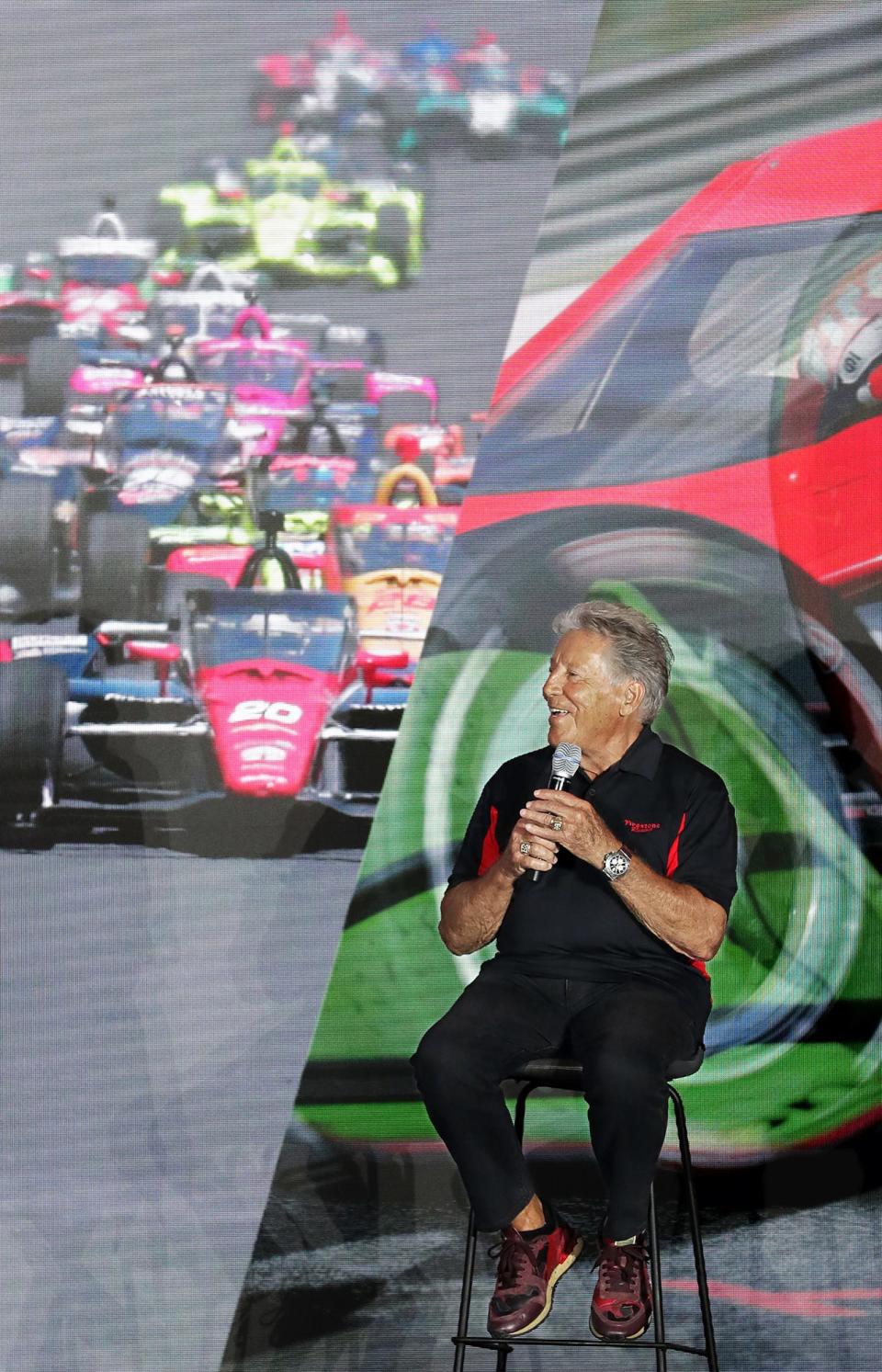 Racing legend Mario Andretti smiles as he speaks about Firestone tires during the grand opening ceremony for the Bridgestone Advanced Tire Production Center in Akron on Wednesday.