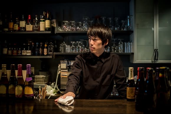 Young bartender in a contemporary Japanese bar.