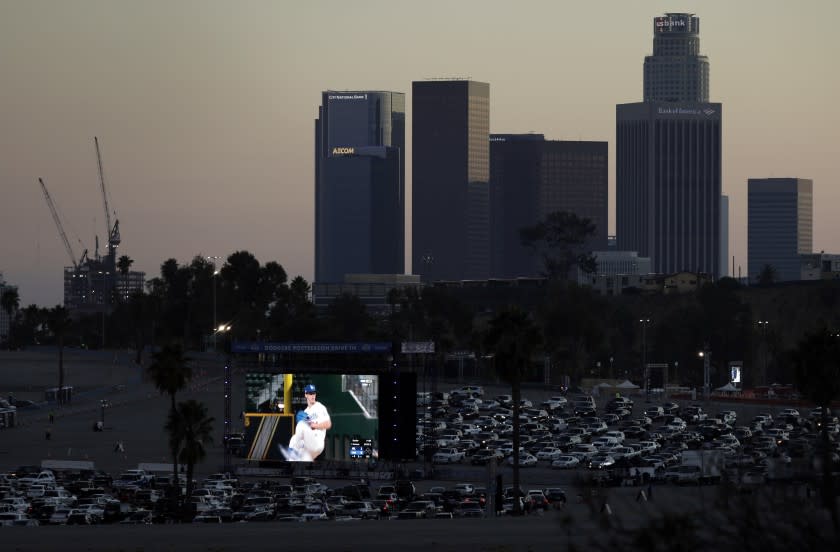 LOS ANGELES, CA - OCTOBER 12: Fans drive into Dodger Stadium on Monday, Oct. 12, 2020 in Los Angeles, CA for a drive-in viewing party for the National League Championship Series against the Atlanta Braves in Arlington, Texas. (Myung J. Chun / Los Angeles Times)