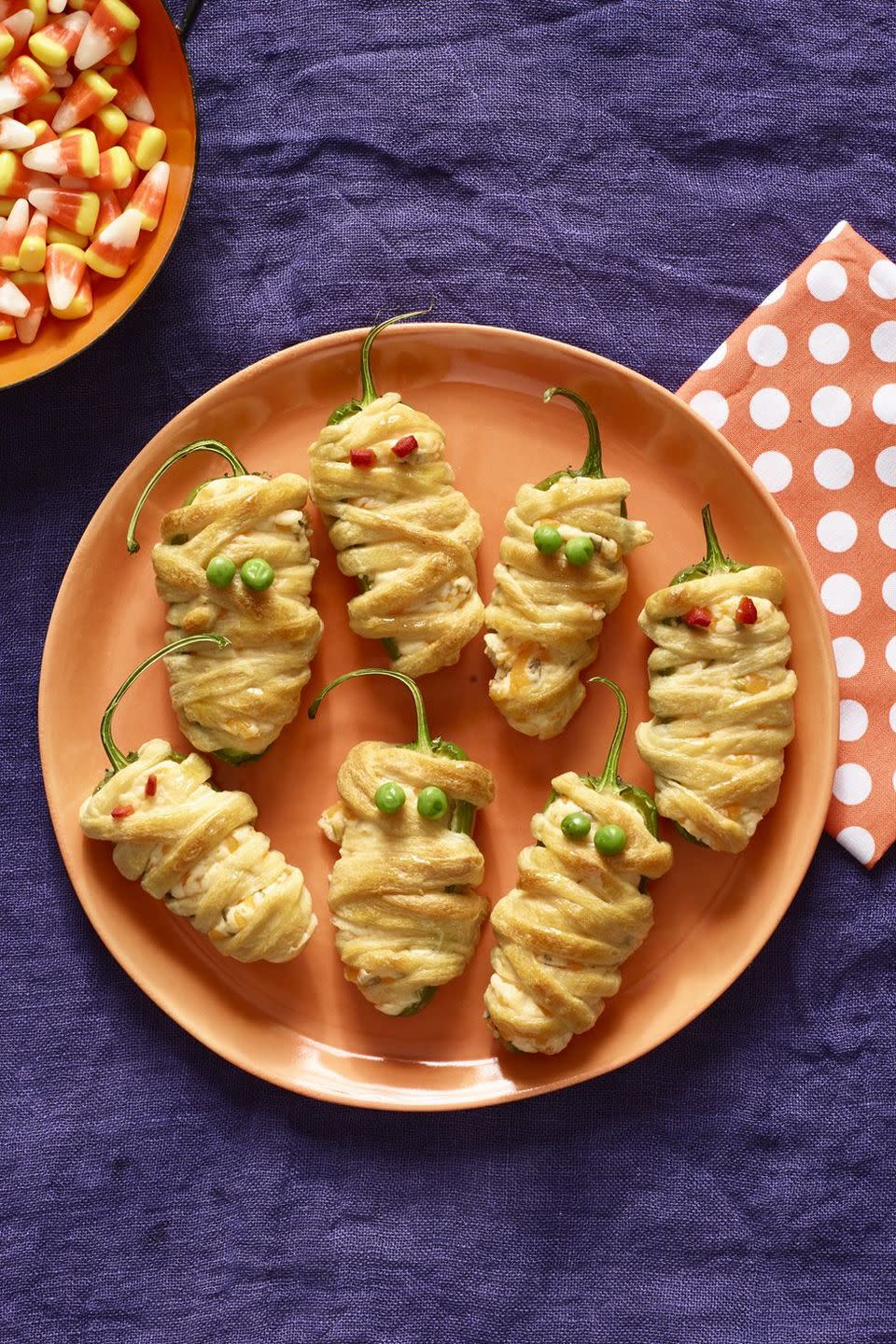 <p>These jalapeno poppers will be the hit of your Halloween party.</p><p>Get the <strong><a href="https://www.womansday.com/food-recipes/food-drinks/recipes/a56191/hot-pepper-mummies-recipe/" rel="nofollow noopener" target="_blank" data-ylk="slk:Hot Pepper Mummies recipe;elm:context_link;itc:0;sec:content-canvas" class="link ">Hot Pepper Mummies recipe</a></strong> from Woman's Day. </p>