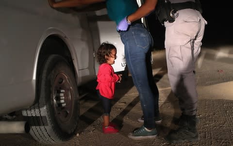 A two-year-old Honduran asylum seeker cries as her mother is searched and detained near the U.S.-Mexico border on June 12, 2018 - Credit: John Moore/Getty Images