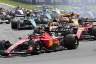 Ferrari driver Charles Leclerc of Monaco, McLaren driver Oscar Piastri of Australia and Ferrari driver Carlos Sainz of Spain steer into the first corner during the Formula One Grand Prix at the Spa-Francorchamps racetrack in Spa, Belgium, Sunday, July 30, 2023. (AP Photo/Geert Vanden Wijngaert)