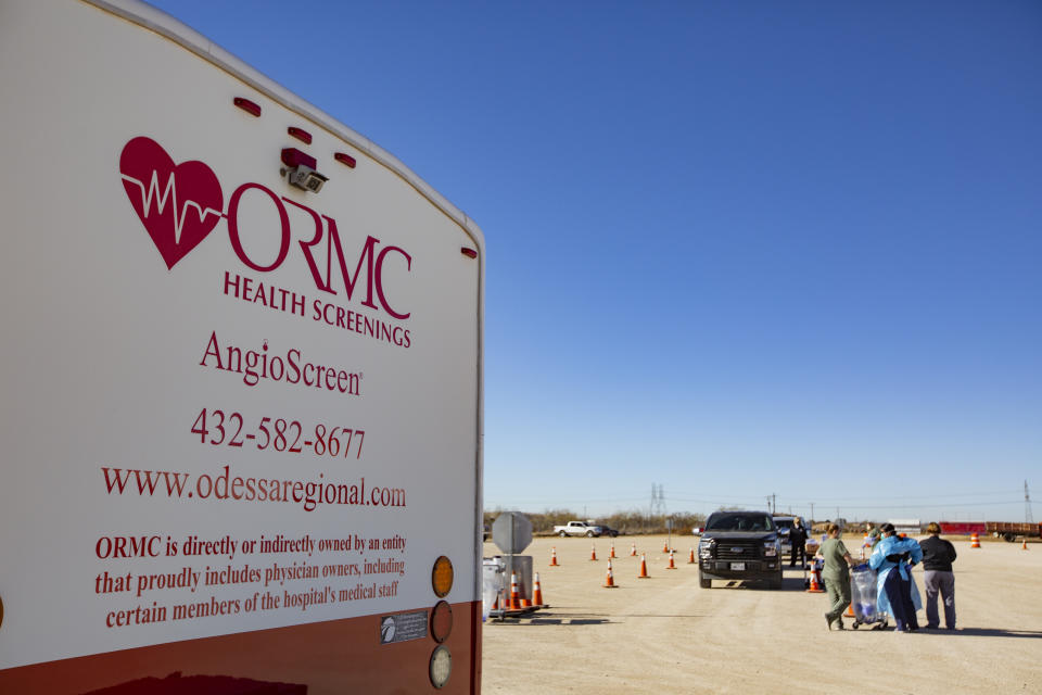 Odessa Regional Medical Center hosted free COVID-19 testing for Ector County residents at the West Texas Horse on Dec. 8, 2020, in Odessa, Texas. The next drive-thru testing will be Friday at the Ector County Coliseum from 10 a.m. to 1:30 p.m. or until they exhaust their testing kits. Vehicles can begin lining up at 8:30 a.m. (Jacob Ford/Odessa American via AP)