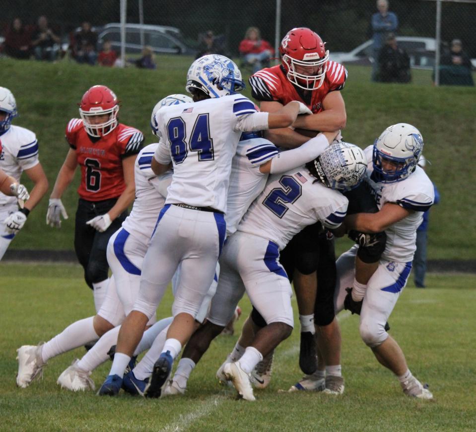 The Dundee defense lifts and brings down Clinton's Jacob Felts Friday night. Dundee fell 54-33.