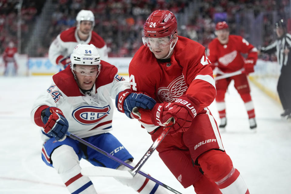 Montreal Canadiens defenseman Jordan Harris (54) battles with Detroit Red Wings center Klim Kostin (24) for the puck in the second period of an NHL hockey game Thursday, Nov. 9, 2023, in Detroit. (AP Photo/Paul Sancya)