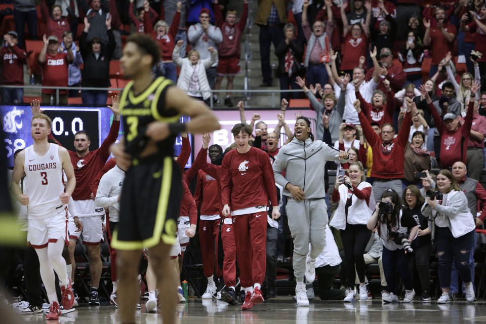 Washington State players and fans celebrate the team's 68-65 win over Oregon in an NCAA college basketball game Sunday, Feb. 19, 2023, in Pullman, Wash. (AP Photo/Young Kwak)